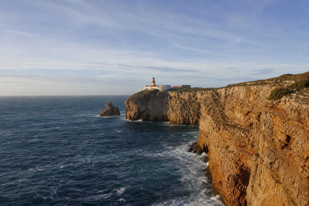 Golden cliffs and sea stacks of the Algarve coast near Lagos on a clear day