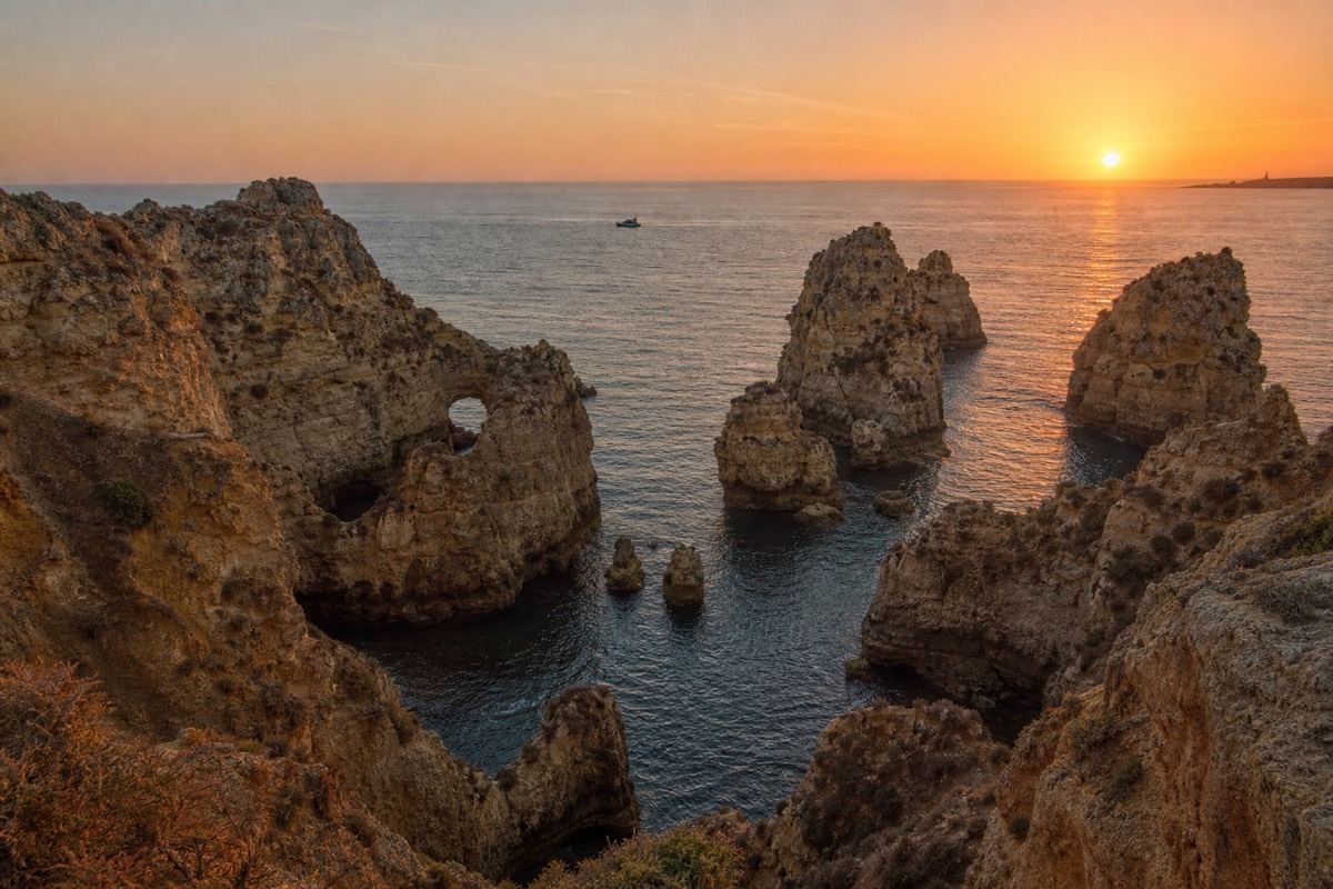Golden hour light on the Ponta da Piedade cliffs from a boat off Lagos