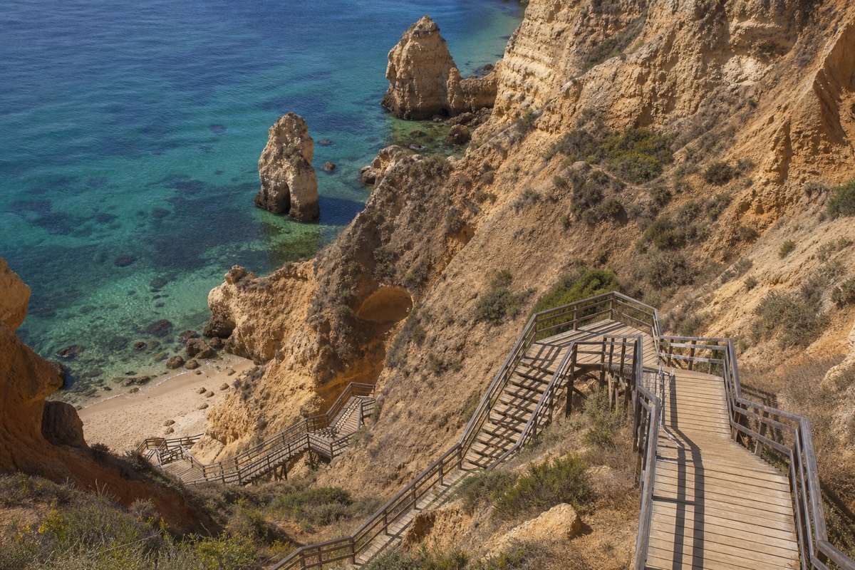 The wooden stairway down to Praia do Camilo